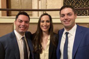 Matthew, Nicole, and Robert Gelb (left to right) are the first triplets to graduate together from Syracuse University School of Law, and be sworn in together to practice law in the Appellate Division of state Supreme Court, Fourth Department. They were among about 220 new attorneys who took the oath on Wednesday at the Eastman Theatre. (Photo by Bennett Loudon)