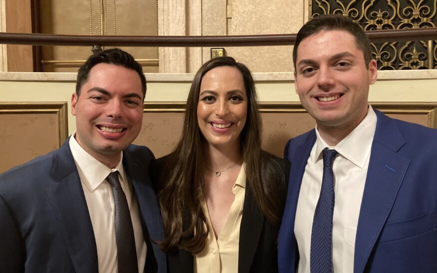 Matthew, Nicole, and Robert Gelb (left to right) are the first triplets to graduate together from Syracuse University School of Law, and be sworn in together to practice law in the Appellate Division of state Supreme Court, Fourth Department. They were among about 220 new attorneys who took the oath on Wednesday at the Eastman Theatre. (Photo by Bennett Loudon)